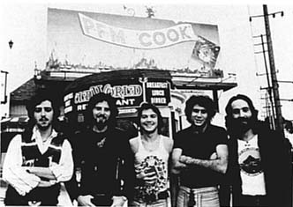 PFM(1974) on Sunset Boulevard in Los Angeles, with big Billboard promo of the album "Cook":Premoli/Djivas/Pagani/Mussida/Di Cioccio